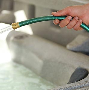 Filling up the spa with water using a hose
